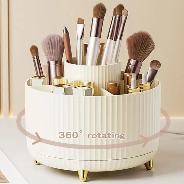 The UNIQ Rotating Makeup Organiser - Cream White by UNIQ is a round organiser with vertical grooves, elegant gold legs, and 360-degree spinning for easy access to brushes, lipsticks, and cosmetics.