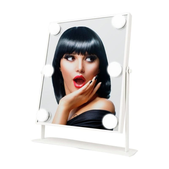 A woman with short black hair and bangs, wearing off-shoulder black clothing, poses with her mouth open and hand on her chin. Shes framed in the UNIQ XL Hollywood make-up mirror with 6 LED bulbs and touch function by UNIQ.